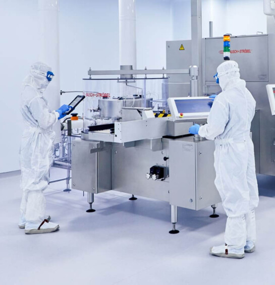 Two people in white lab suits working on innovative medications.